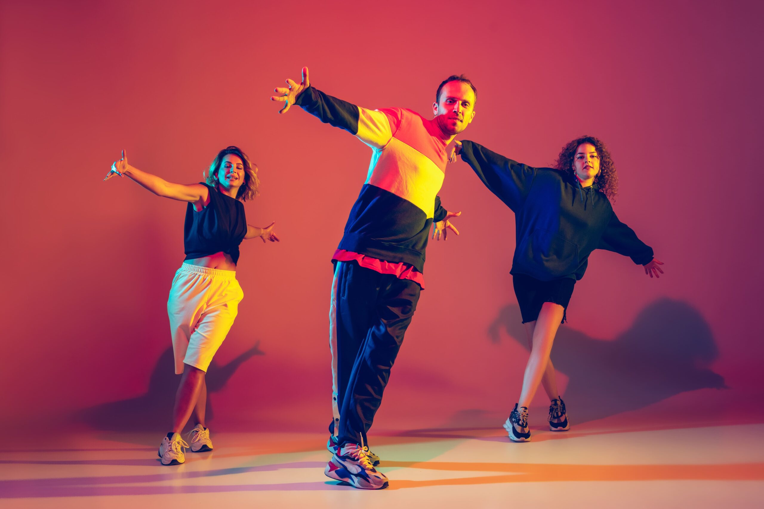 stylish young man women dancing hip hop bright clothes gradient background dance hall neon ligh 1 1 1 scaled